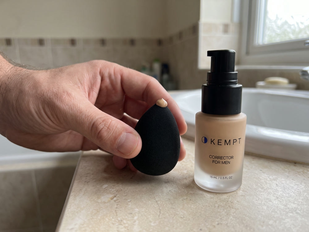 One drop of Kempt on the tip of a small black sponge, next to the bottle